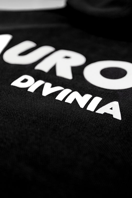 Black shirt with white text 'NURO' and 'DIVINIA' on a dark background