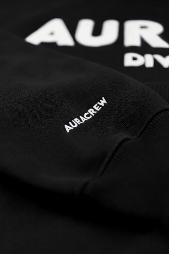 Black sweatshirt with 'AURCREW' branding on a dark background