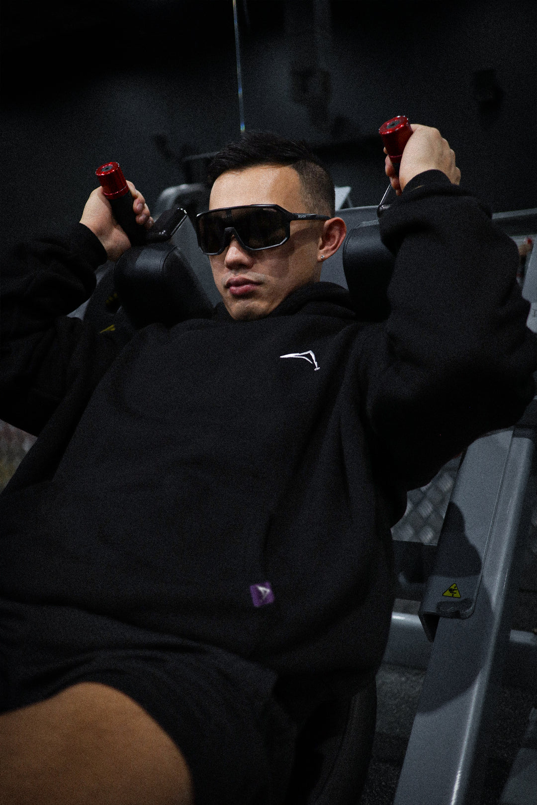 Aurora Divinia Divine Black Hoodie — oversized black hoodie with white Aurora Divinia logo on chest, Act 1.0 collection. At the Gym.